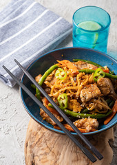 Asian noodles with pork in teriyaki sauce, with green beans, carrots and shiitake mushrooms.