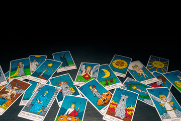 Tarot cards distributed randomly on top of each other