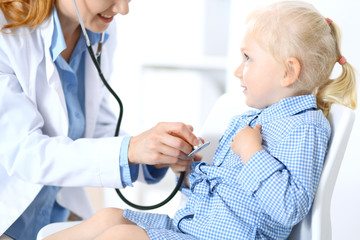 Doctor and a little blonde girl. Usual health exam. Medicine and healthcare concept