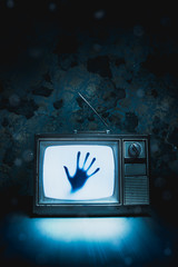 Retro television with white noise and a hand inside/ high contrast image
