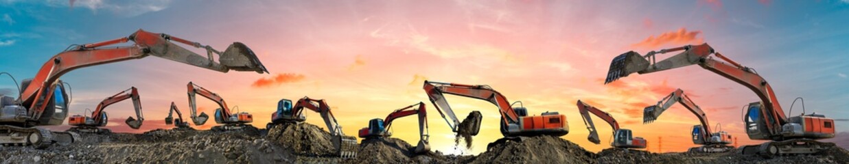 Many excavators work on construction site at sunset,panoramic view