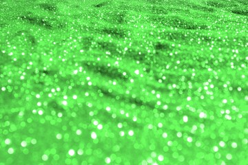green bright aluminium sand made of glitters - holiday concept with bokeh texture - beautiful abstract photo background