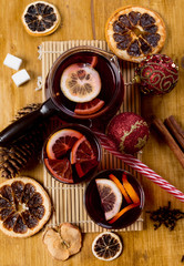 Mulled wine in glasses with spices on wooden background,top view.
