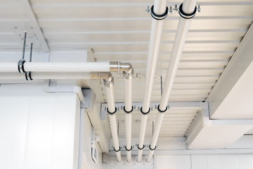 plastic pipes of a heating system on a building ceiling