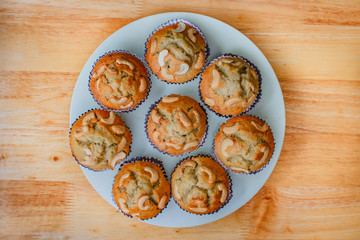 Homemade banana cupcake with wood background.