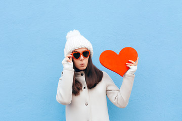 Cute Funny in Love Girl Holding Big Heart on Blue Background