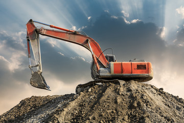 Excavator work on construction site at sunset