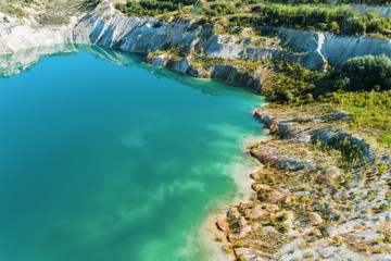 Inactive gypsum quarry. In the quarry is a lake with blue water