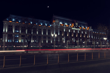 Fototapeta na wymiar 13 DEC 2018 Romania. Bucharest Court of Appeal by night. Blured lights from passing cars. Long exposure image. Selective focus.