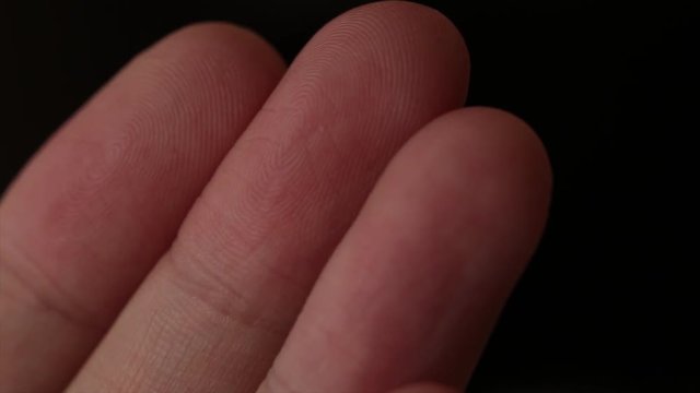 Extreme closeup view of a finger print on a human fingers