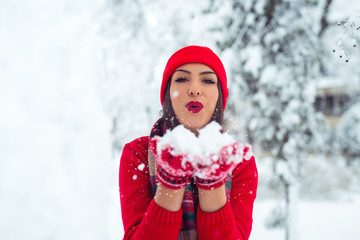 Beautiful woman standing among snowy trees in winter forest - Image