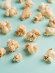 popcorn on blue background. Movie background with copy space. Vertical. Selective focus.