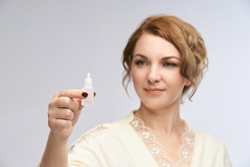 Woman apply eye drops. Girl glaucoma treatment