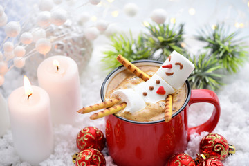 Red mug with cappuccino with melted marshmallow snowman