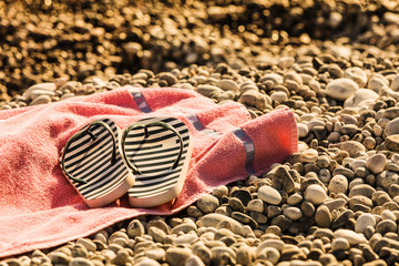 Flip flops on sunbathing towel