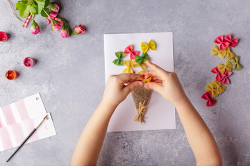 Paper crafts for mother day, 8 march or birthday. Small child doing a bouquet of flowers out of...