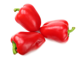 three red sweet bell peppers isolated on white background. top view