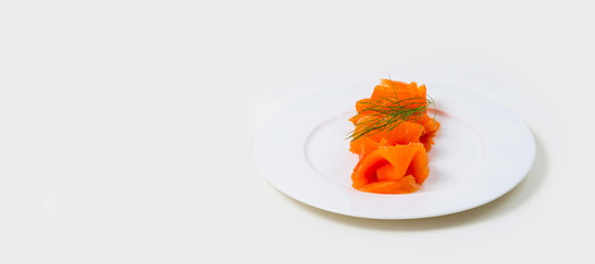 Slices of folded Salmon on a white plate on a white background