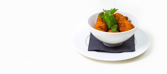Fried Food in a white bowl on a white plate on a white background