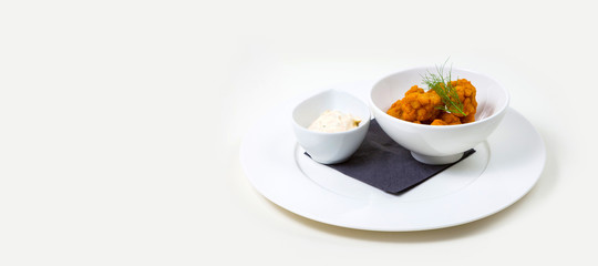 Cheese Poppers and dip in a white bowl on a white plate on a white background isolated