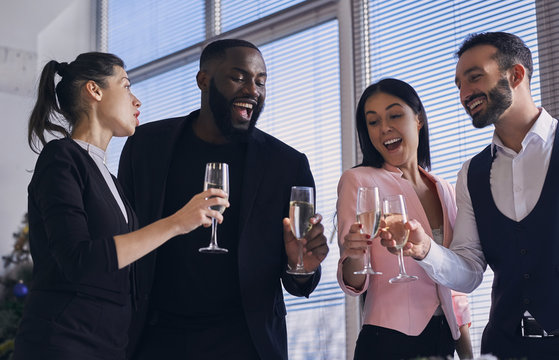 The happy business people drinking champagne