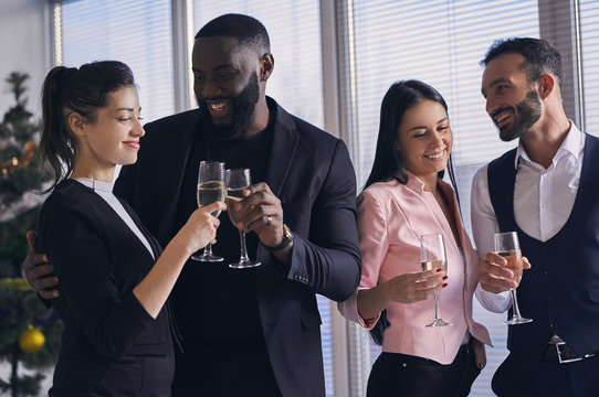 The happy business people drinking champagne in the office