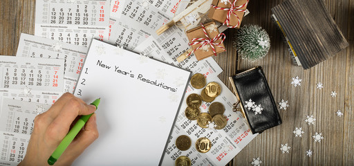 New Year's Resolutions. Small purse with coins on the New Year's background.