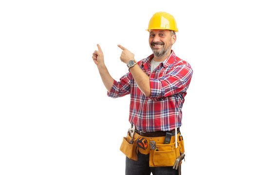 Workman pointing at blank copyspace behind. - Powered by Adobe