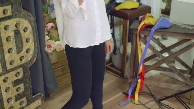 Body of girl in black trousers during photo session of fanny packs