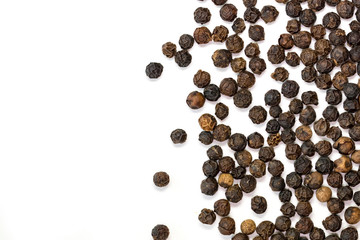 image of black pepper seeds on white background. Food.