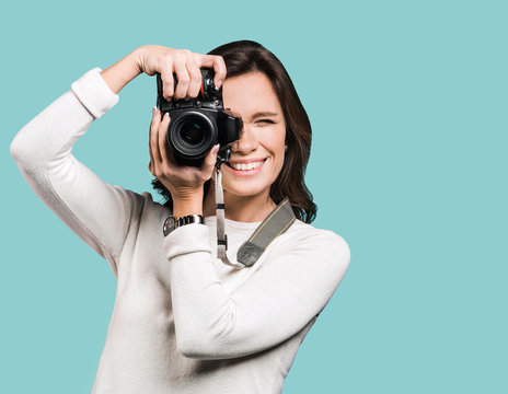 Woman photographer takes images with dslr camera