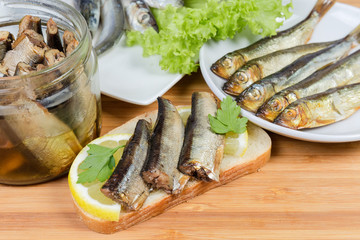 Open sandwich with preserved smoked sprats close-up