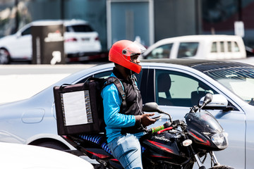 DUBAI, UAE - OCTOBER 18: Man on motorbycicle stay in Traffic Jam at Sheikh Zayed Road in Dubai, United Arab Emirates