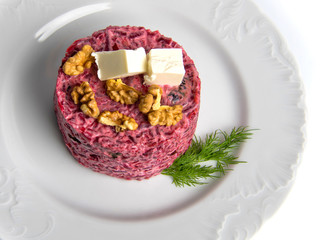 Beetroot salad on a plate isolated on a white background.