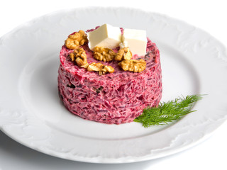 Beetroot salad on a plate isolated on a white background.