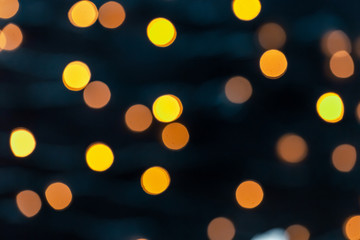 Christmas light background. Holiday glowing backdrop. Defocused background with blurred bokeh.