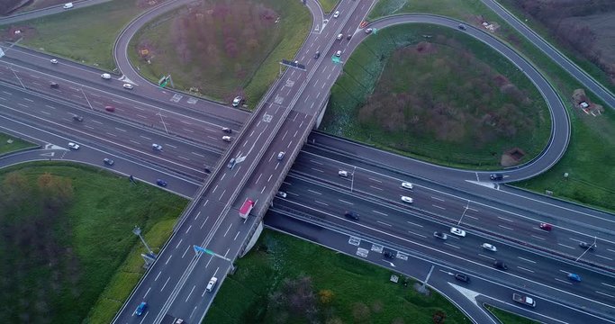Cloverleaf interchange seen from above. Aerial view of highway road junction in the Po valley near Milan at sunset. Bird's eye view.