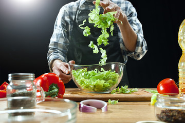 Preparing salad. Female chef cutting fresh vegetables. Cooking process. Selective focus. The healthy food, kitchen, salad, diet, cuisine, organic concept