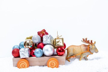 Deer pulling the cart (Santa's sleigh) with a mountain of gifts on snow drifts. The concept of approaching family holidays and Christmas