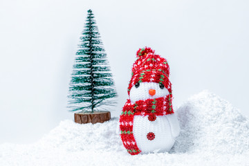 Christmas tree with snowman in snow drift. Free space for your text