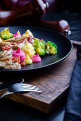 delicious Beef Strogans Restaurant Dish in restaurant background. Healthy exclusive food on big black platter closeup