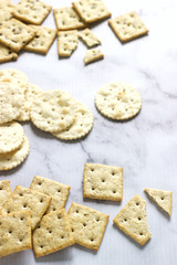 Matzo crackers, salty crackers with sesame seeds and flax seeds on a light background.