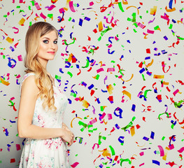Obraz na płótnie Canvas Happy fashion model woman on holiday confetti background