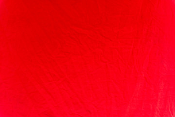 A crumpled red tarpaulin as a background