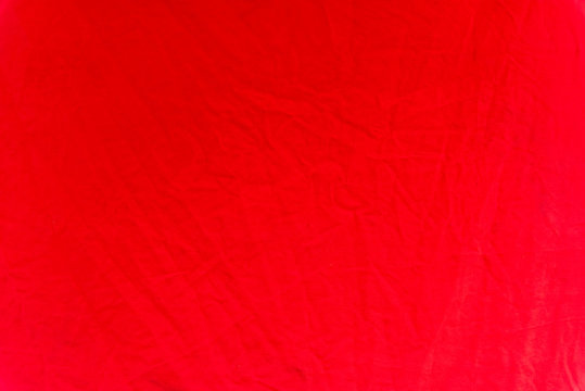 A crumpled red tarpaulin as a background