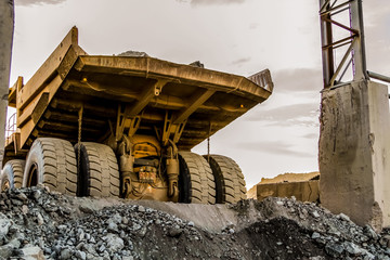 Fototapeta na wymiar Mining dump trucks transporting Platinum ore for processing