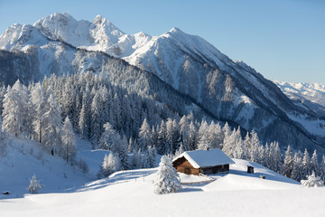  Winter wonderland in the Alps with traditional mountain chaletю Picturesque winter scene.