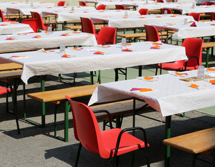 many tables set outdoors for a big lunch