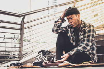 Male Beggar waiting money, coins from Human kindness, Homeless in the city