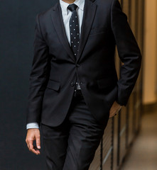 cropped head of Arab Indian hands and arms of businessman in a suit